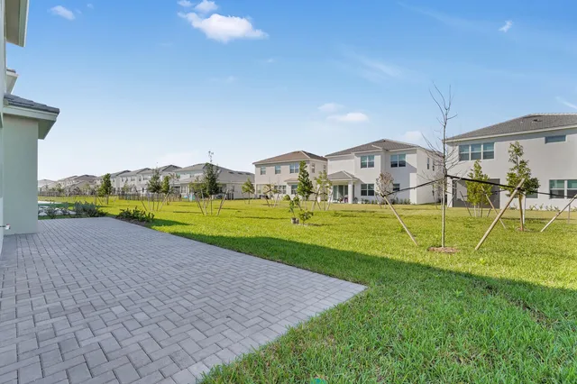 a view of yard with swimming pool and green space