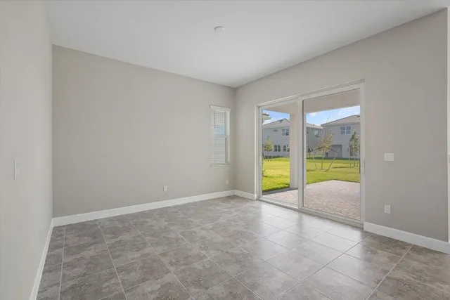 a view of an empty room with glass door