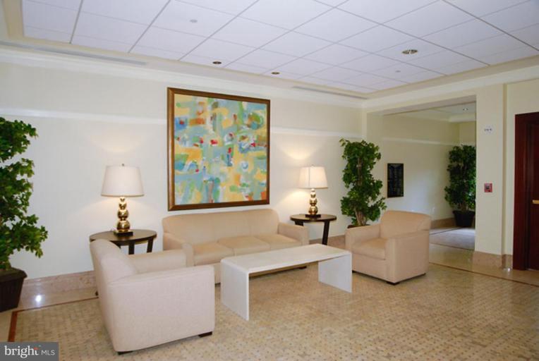 2425 L Street Northwest, Unit 617 Washington, DC 20037 - Photo 5 of 8 a living room with furniture and a large window
