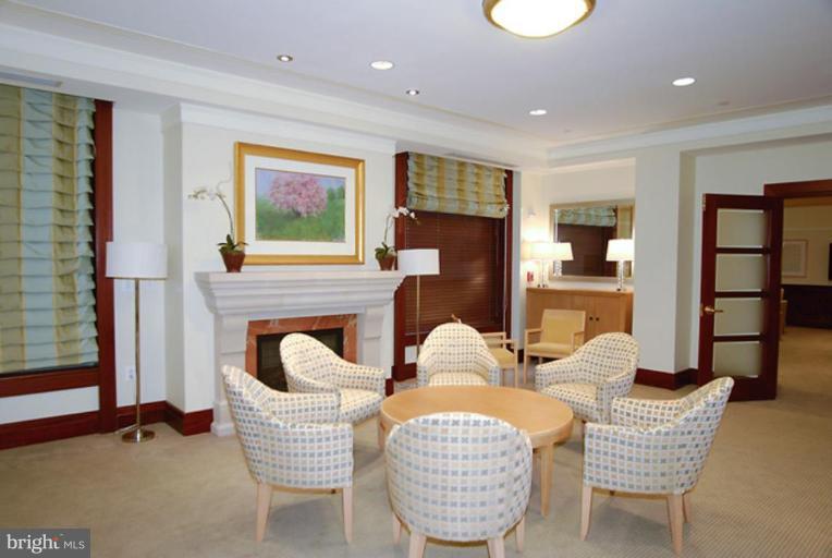 2425 L Street Northwest, Unit 617 Washington, DC 20037 - Photo 7 of 8 a living room with fireplace furniture and a large window