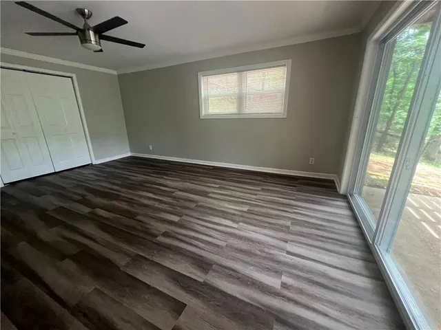 a view of a room with wooden floor and windows