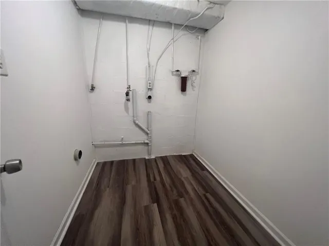 a view of a room with wooden floor