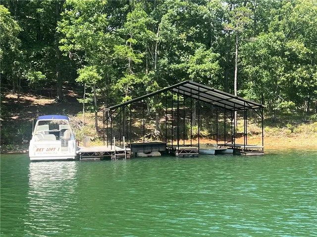 a view of a swimming pool with lawn chairs under an umbrella