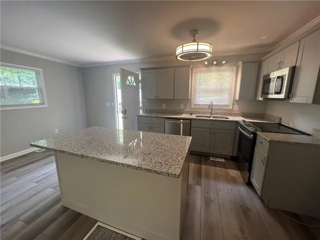 a kitchen with center island table and chairs
