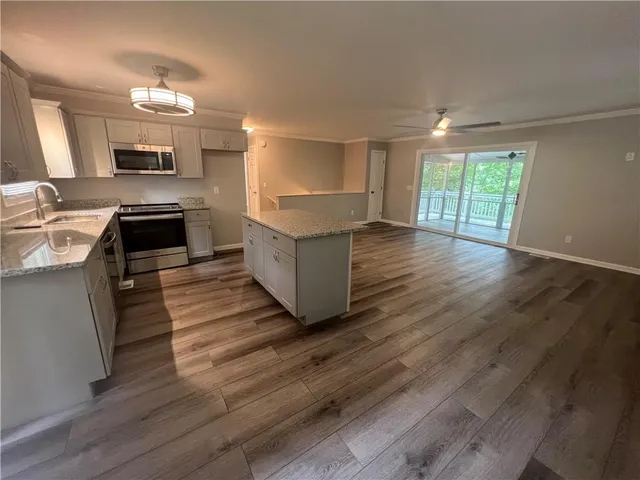 a kitchen with sink and cabinets