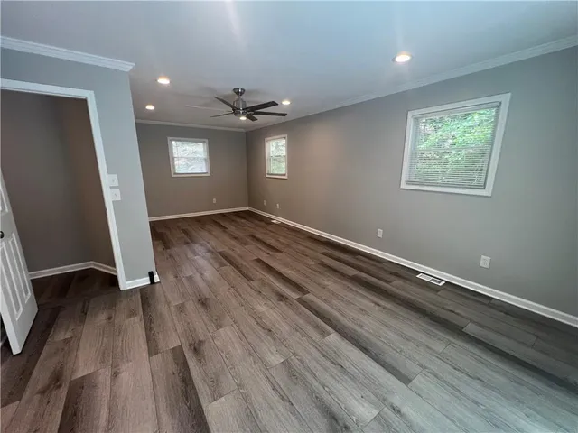 wooden floor in an empty room with a window
