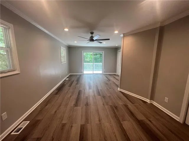 wooden floor in an empty room with a window