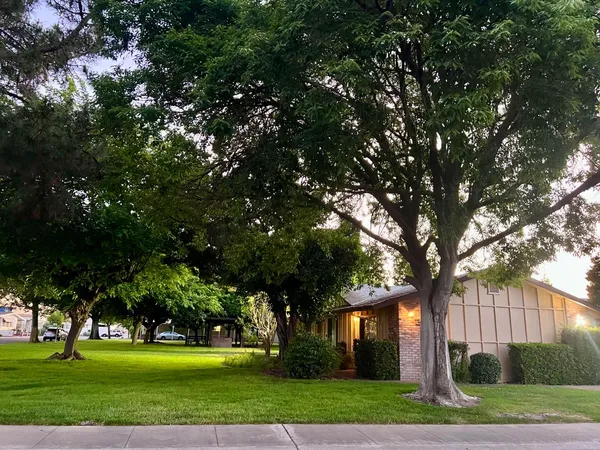 a front view of a house with a garden