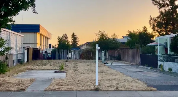a view of a house with trees in the background