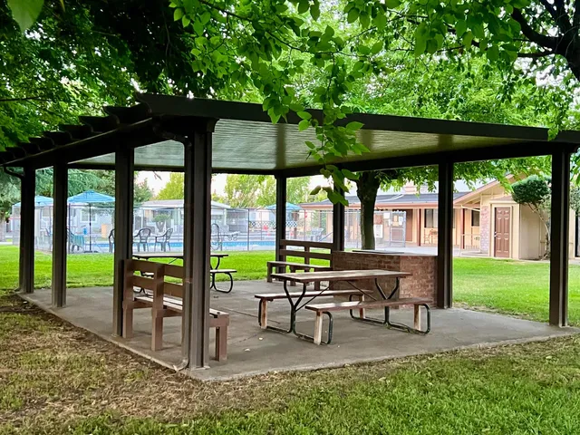 a view of a patio with a table chairs and a backyard