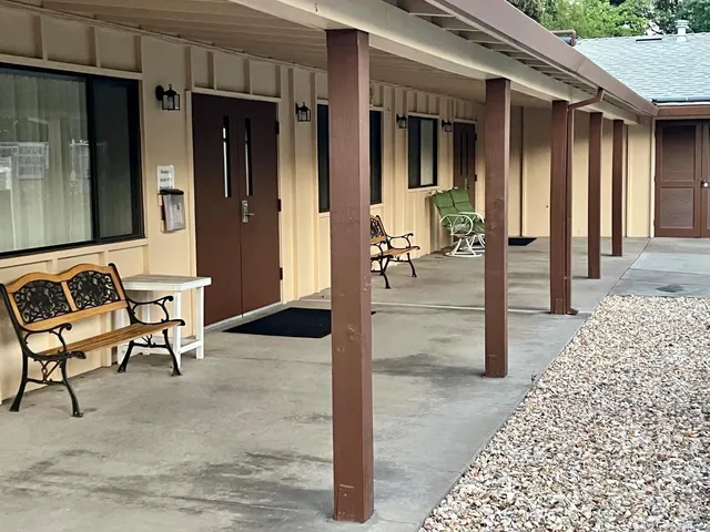 a view of a hallway with dining area and glass door