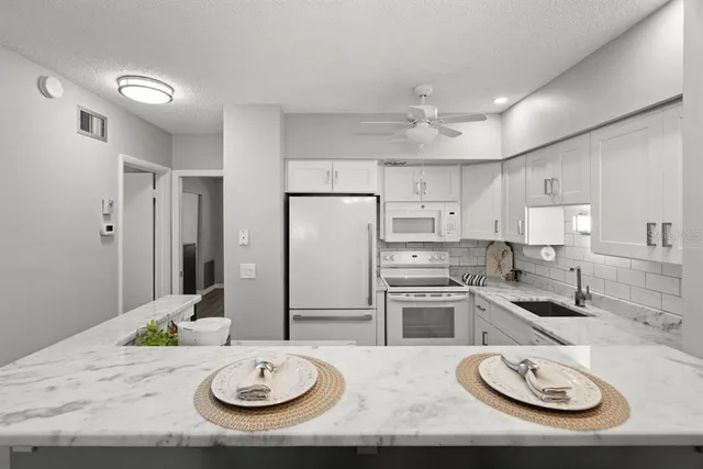 a living room with furniture fireplace and flat screen tv