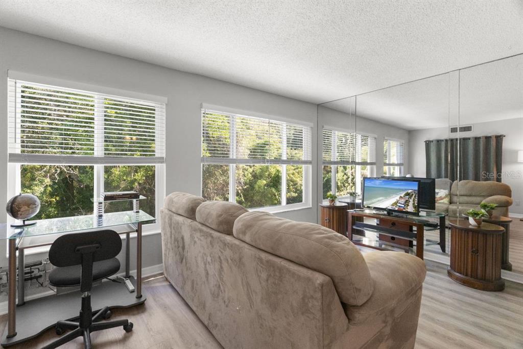 2391 Sumatran Way, Unit 69 Clearwater, FL 33763 - Photo 18 of 50 a living room with furniture and a large window