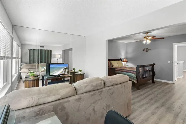 a room with lots of chairs and a dining table with wooden floor