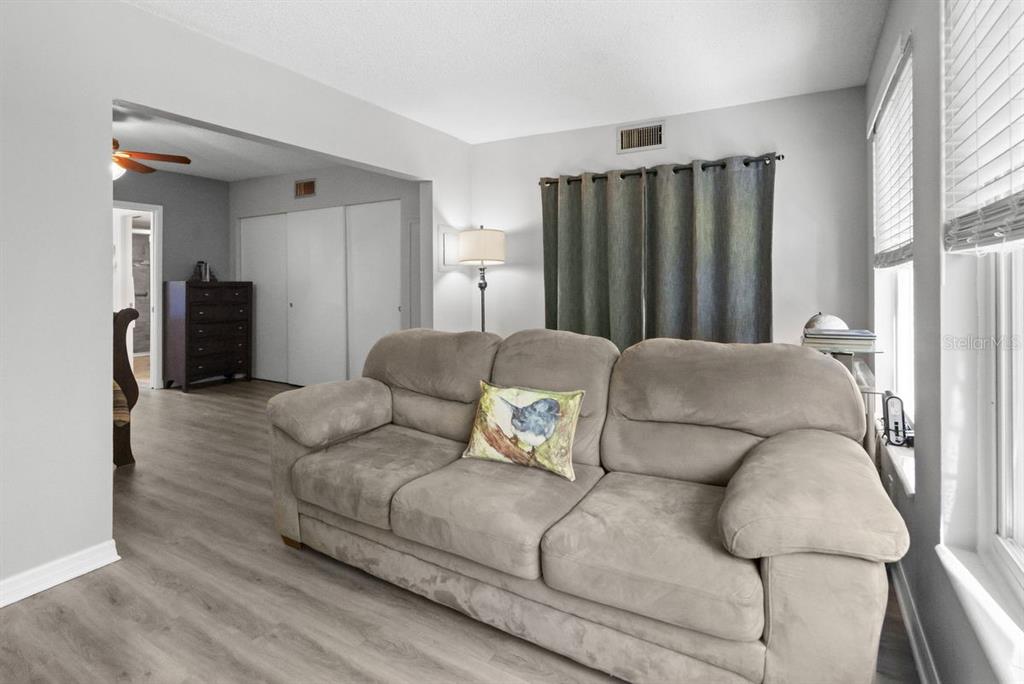 2391 Sumatran Way, Unit 69 Clearwater, FL 33763 - Photo 20 of 50 a living room with furniture and a refrigerator