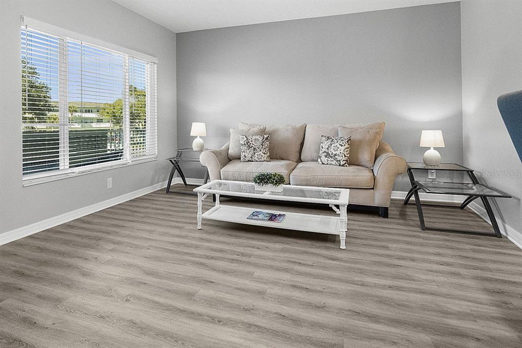 2391 Sumatran Way, Unit 69 Clearwater, FL 33763 - Photo 22 of 50 a living room with furniture and a wooden floor