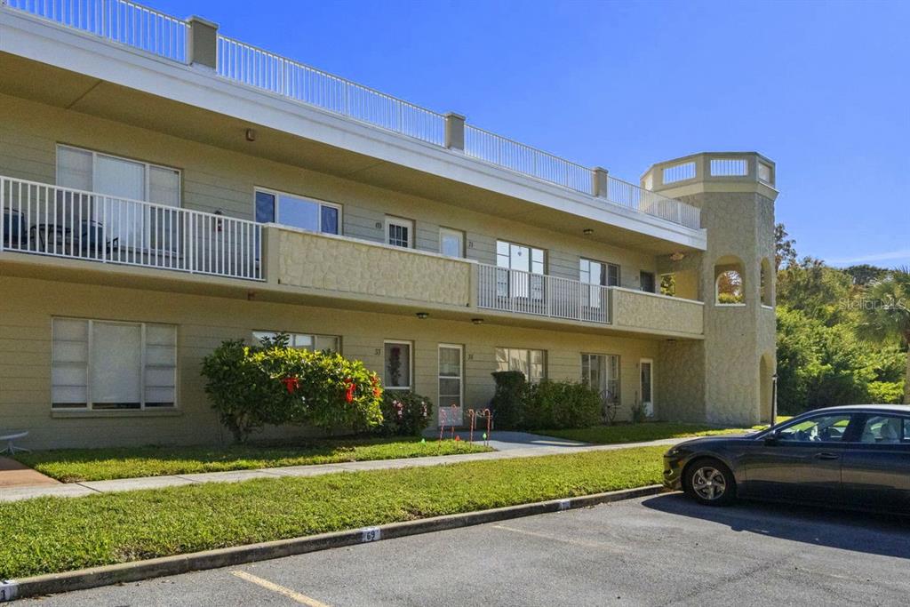 2391 Sumatran Way, Unit 69 Clearwater, FL 33763 - Photo 26 of 50 a car parked in front of a building
