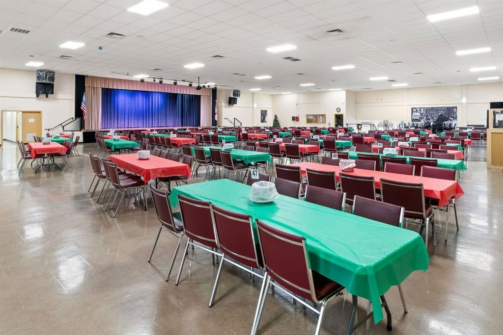 2391 Sumatran Way, Unit 69 Clearwater, FL 33763 - Photo 29 of 50 a room with lots of chairs and a dining table with wooden floor
