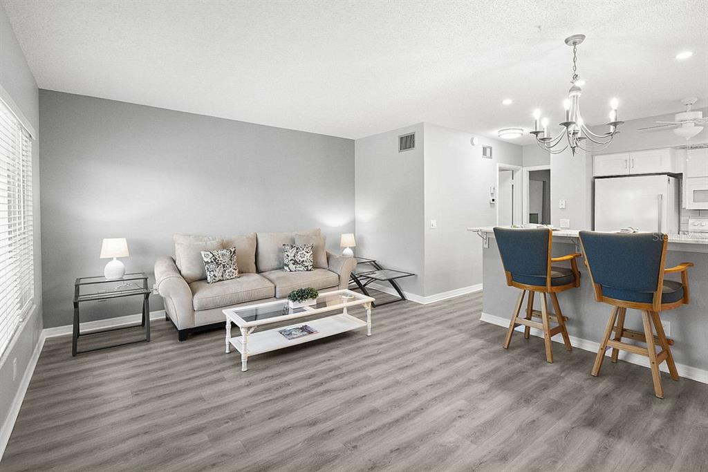 2391 Sumatran Way, Unit 69 Clearwater, FL 33763 - Photo 3 of 50 a living room with furniture and a wooden floor