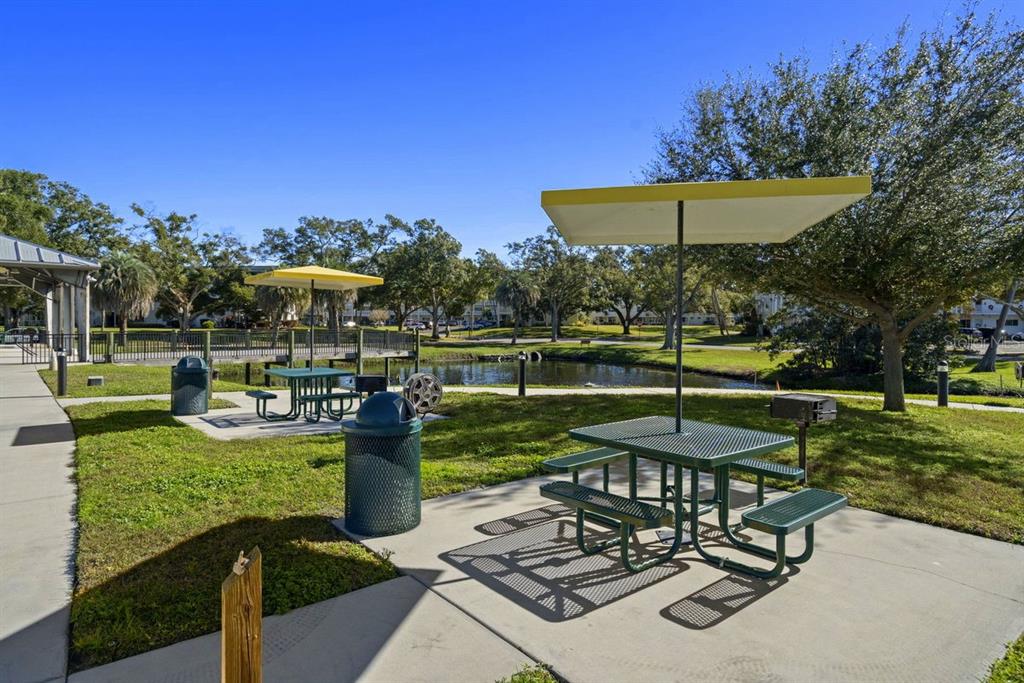 2391 Sumatran Way, Unit 69 Clearwater, FL 33763 - Photo 38 of 50 a view of a table and chairs under an umbrella
