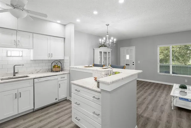 a living room with furniture and a refrigerator