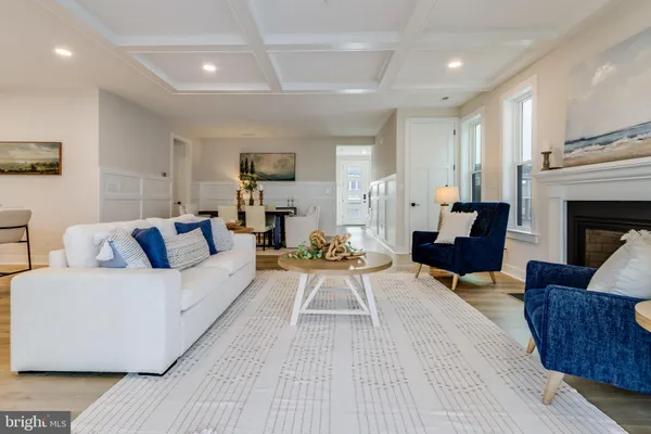 a kitchen with stainless steel appliances granite countertop a sink a stove and a wooden floors