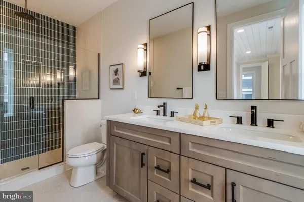 a bathroom with a sink vanity and mirror
