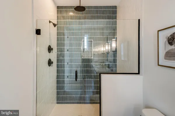 a white toilet sitting next to a bath tub