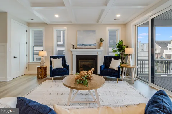 a living room with furniture fireplace and a large window