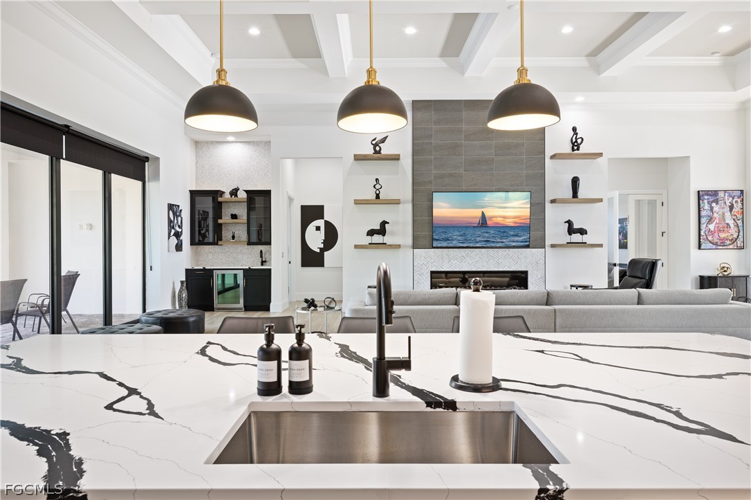 3337 Chestnut Grove Drive Alva, FL 33920 - Photo 25 of 50 a kitchen with stainless steel appliances kitchen island granite countertop a sink and a flat screen tv