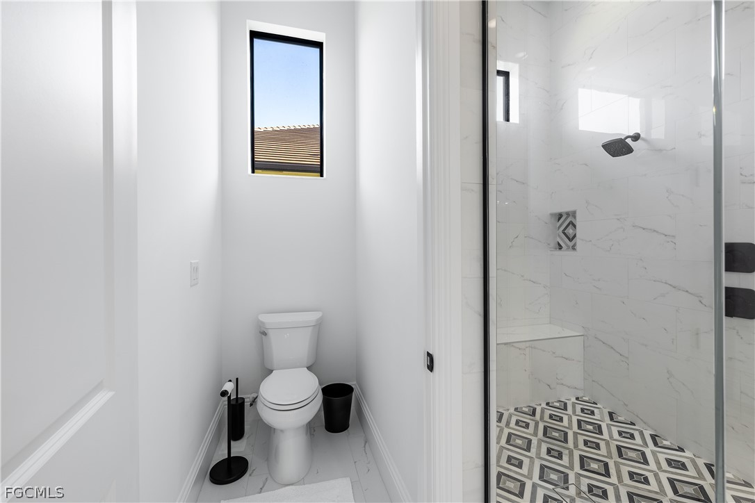 3337 Chestnut Grove Drive Alva, FL 33920 - Photo 33 of 50 a bathroom with a toilet and a shower