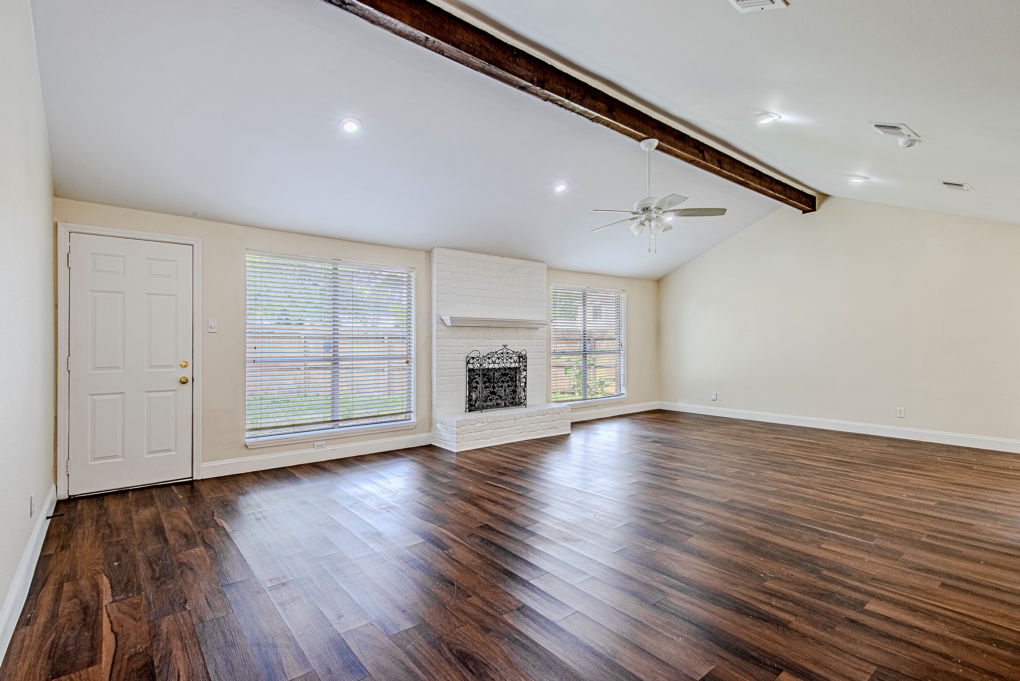 17811 Hawk Haven Lane Spring, TX 77379 - Photo 6 of 22 Spacious main living room featuring rich wood flooring and a cozy fireplace as the focal point.