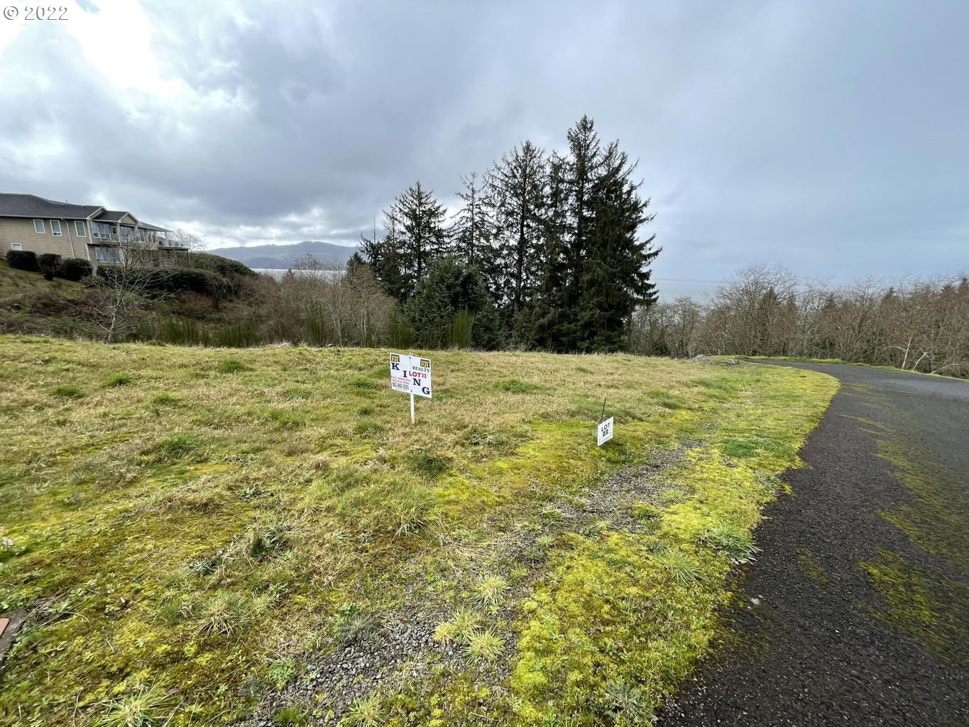 North Ridge, Unit LOT22 Bay City, OR 97107 - Photo 2 of 4 a view of a big yard with an trees