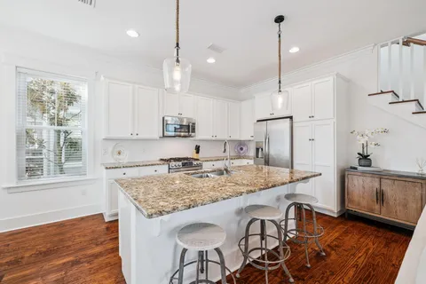a kitchen with stainless steel appliances granite countertop a stove and refrigerator