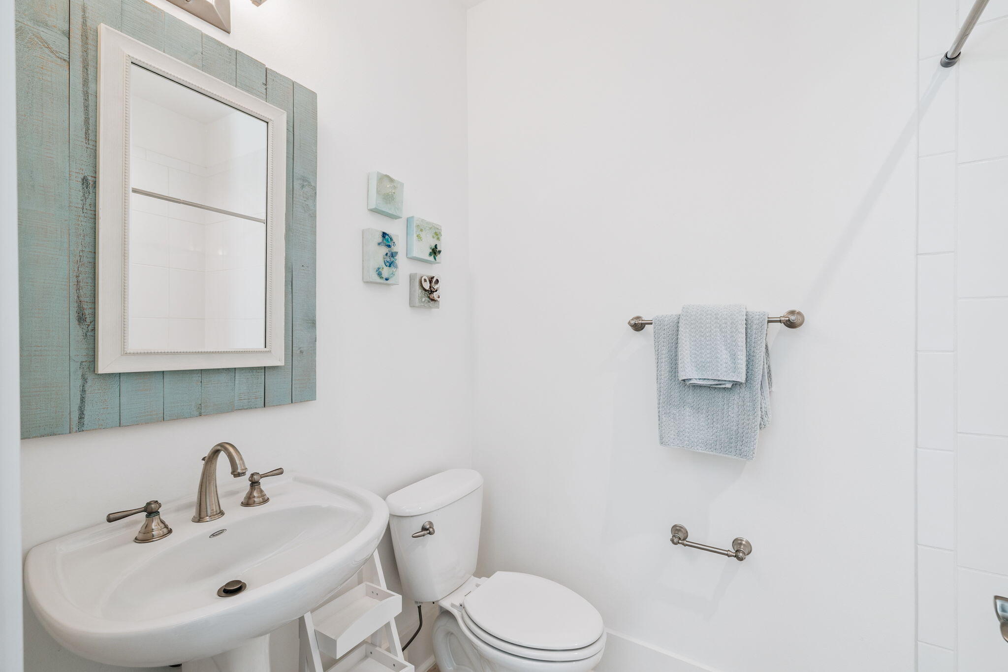 844 Sandgrass Boulevard Santa Rosa Beach, FL 32459 - Photo 45 of 74 a white toilet sitting next to a bathroom sink