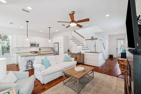 a kitchen with granite countertop white cabinets and stainless steel appliances