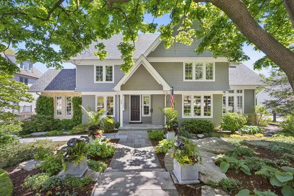 a front view of a house with a yard and outdoor seating