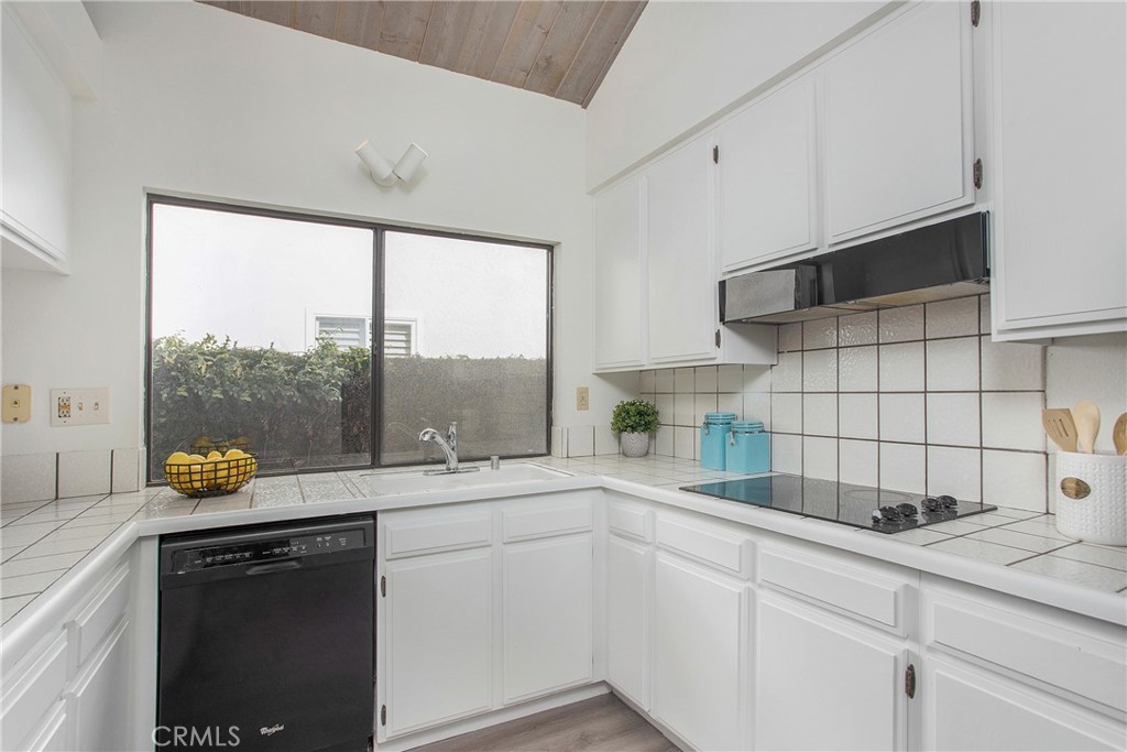 11 Ensueno West Irvine, CA 92620 - Photo 11 of 36 a kitchen with a sink a counter top space and cabinets