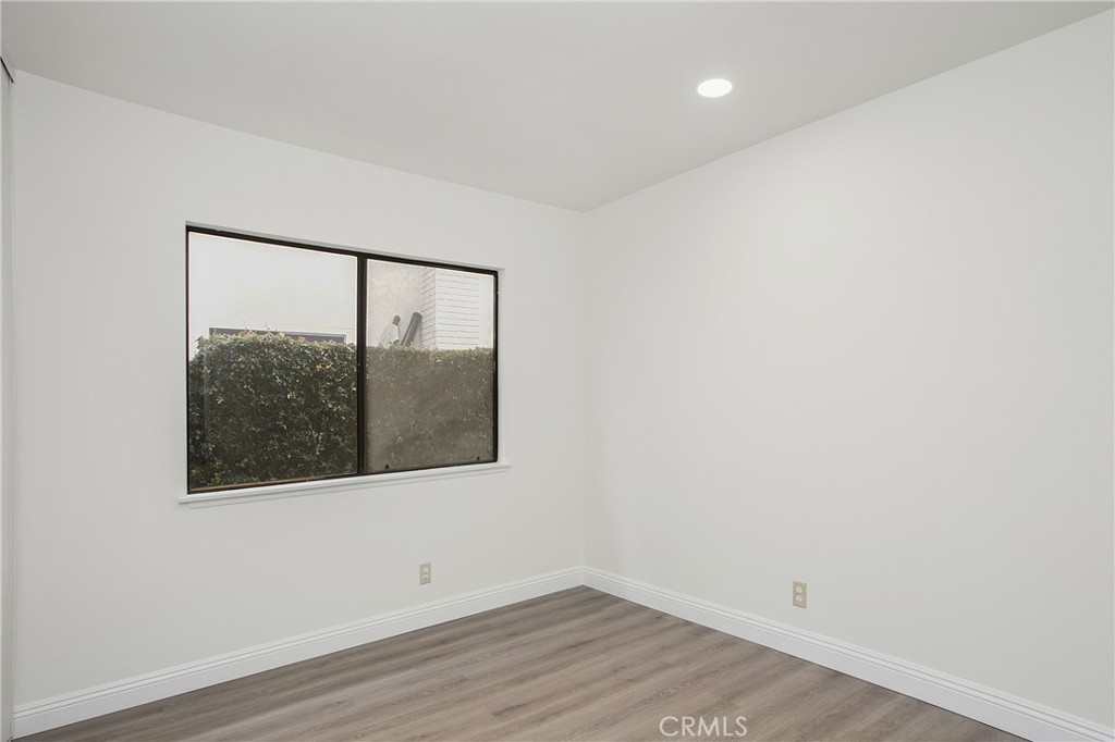 11 Ensueno West Irvine, CA 92620 - Photo 20 of 36 an empty room with wooden floor and a window
