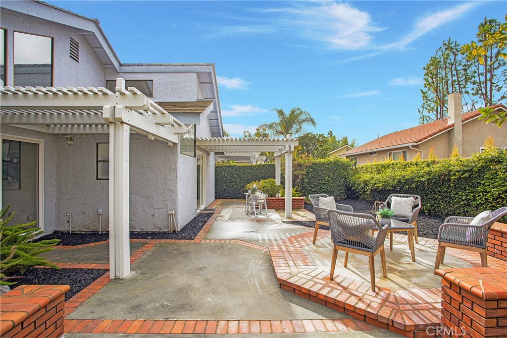 11 Ensueno West Irvine, CA 92620 - Photo 27 of 36 a view of a patio with a table and chairs and potted plants