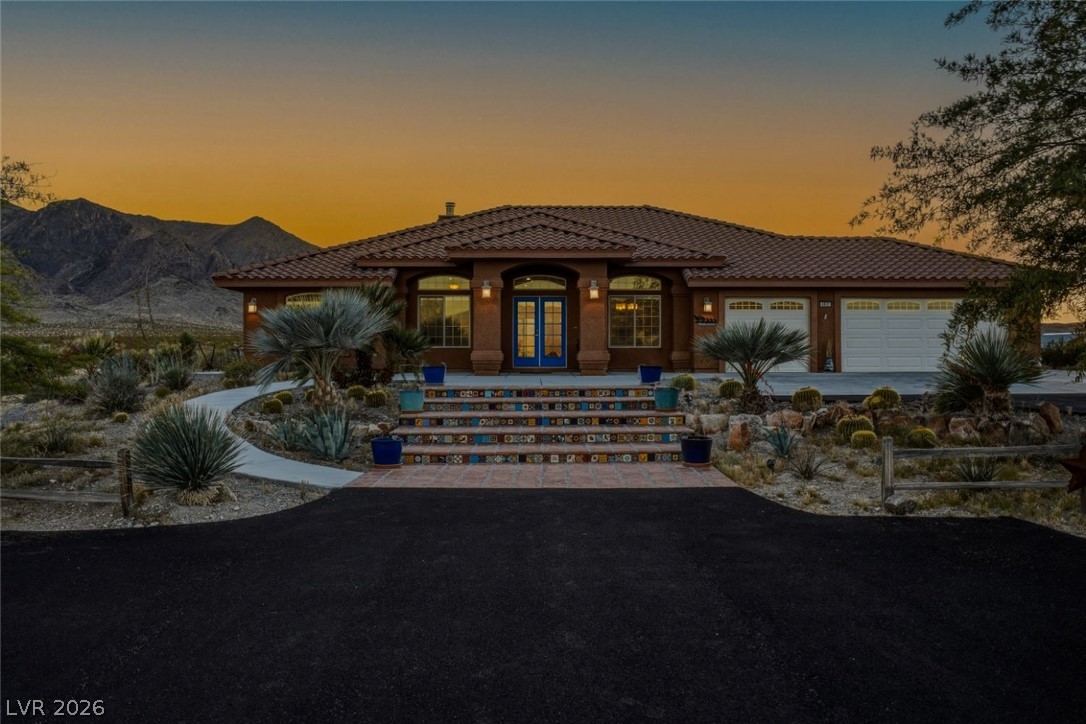 4892 Quail Run Road Pahrump, NV 89060 - Photo 1 of 90 This desert retreat boasts a distinctive tiled entryway, welcoming residents to a tranquil mountain-view setting.