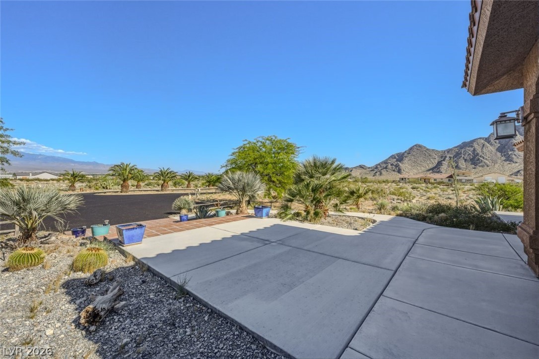 4892 Quail Run Road Pahrump, NV 89060 - Photo 12 of 90 This desert oasis features stunning mountain views, lush landscaping, and a spacious concrete driveway.