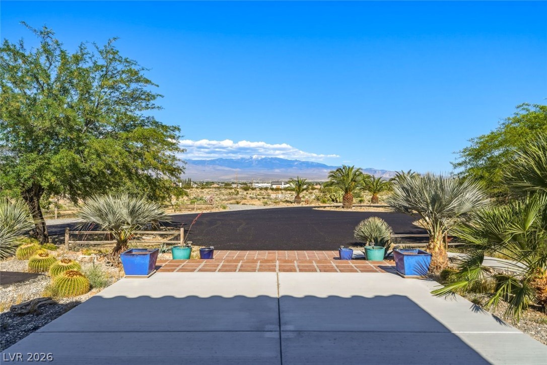 4892 Quail Run Road Pahrump, NV 89060 - Photo 13 of 90 This desert property offers captivating mountain vistas and a spacious, verdant landscape.