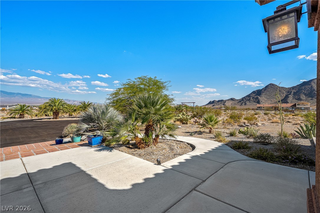4892 Quail Run Road Pahrump, NV 89060 - Photo 14 of 90 This desert oasis features native landscaping and majestic mountain views under an expansive sky.