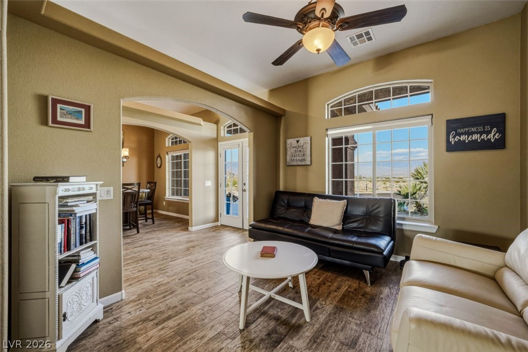 4892 Quail Run Road Pahrump, NV 89060 - Photo 19 of 90 This bright living space features arched doorways and large windows that offer expansive views.