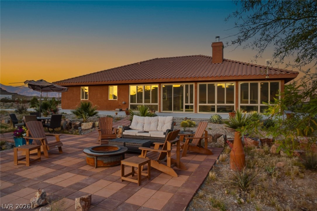 4892 Quail Run Road Pahrump, NV 89060 - Photo 2 of 90 This desert retreat features an expansive patio with fire pit, perfect for evening gatherings.