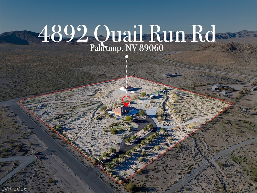 4892 Quail Run Road Pahrump, NV 89060 - Photo 3 of 90 This expansive desert property offers a serene landscape and vast open spaces.