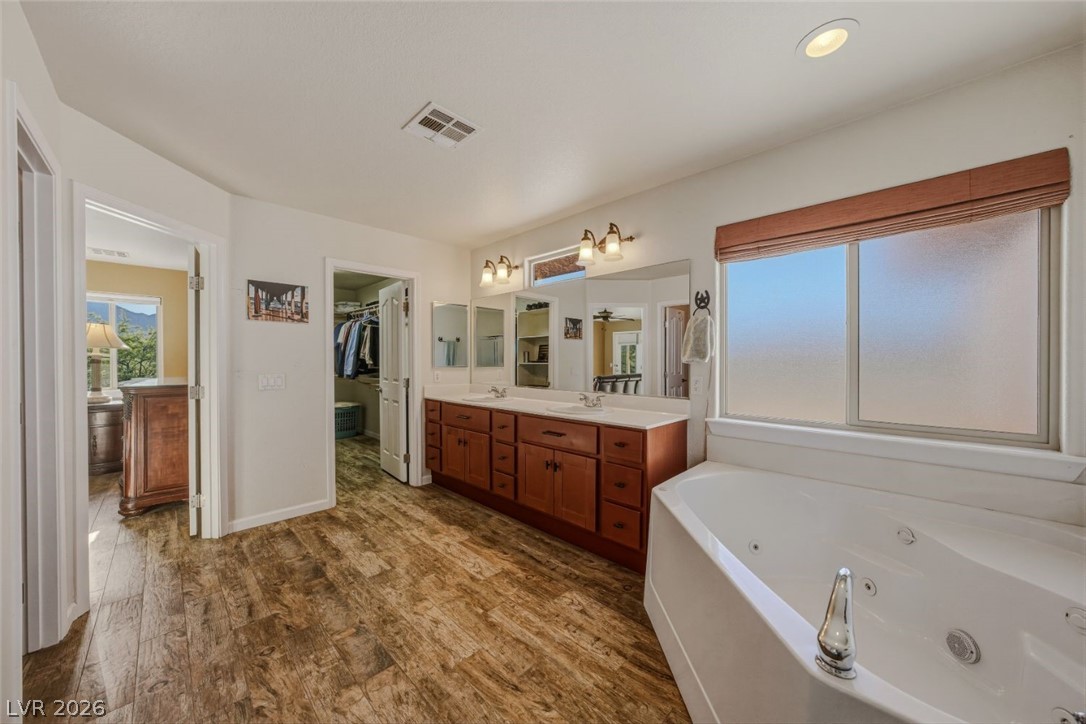 4892 Quail Run Road Pahrump, NV 89060 - Photo 38 of 90 This spacious bathroom offers a large soaking tub and a double vanity for ultimate comfort.