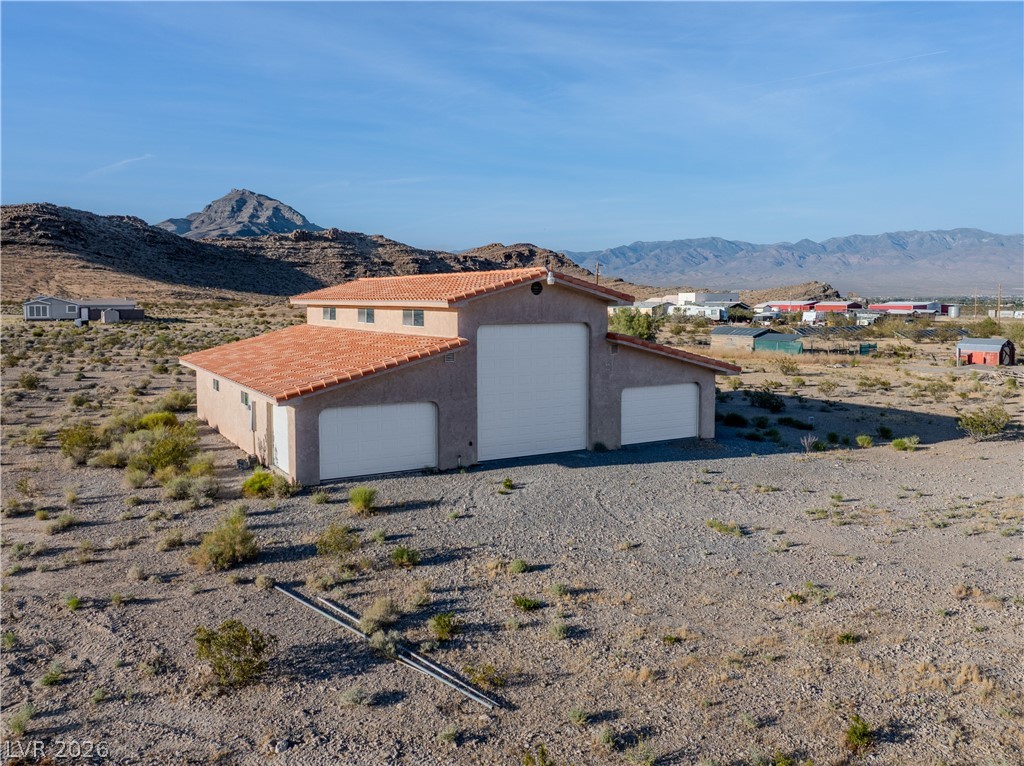 4892 Quail Run Road Pahrump, NV 89060 - Photo 5 of 90 This spacious garage building features multiple bays, providing ample room for vehicles and storage.