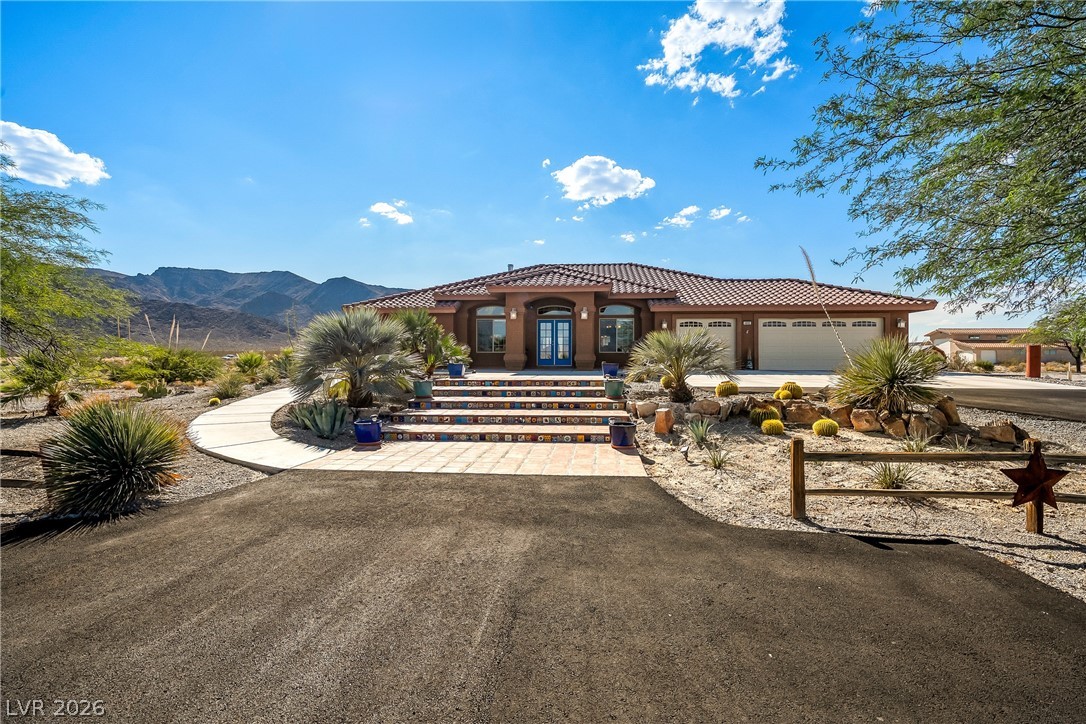 4892 Quail Run Road Pahrump, NV 89060 - Photo 6 of 90 This spacious desert home features a circular driveway and ample garage space.